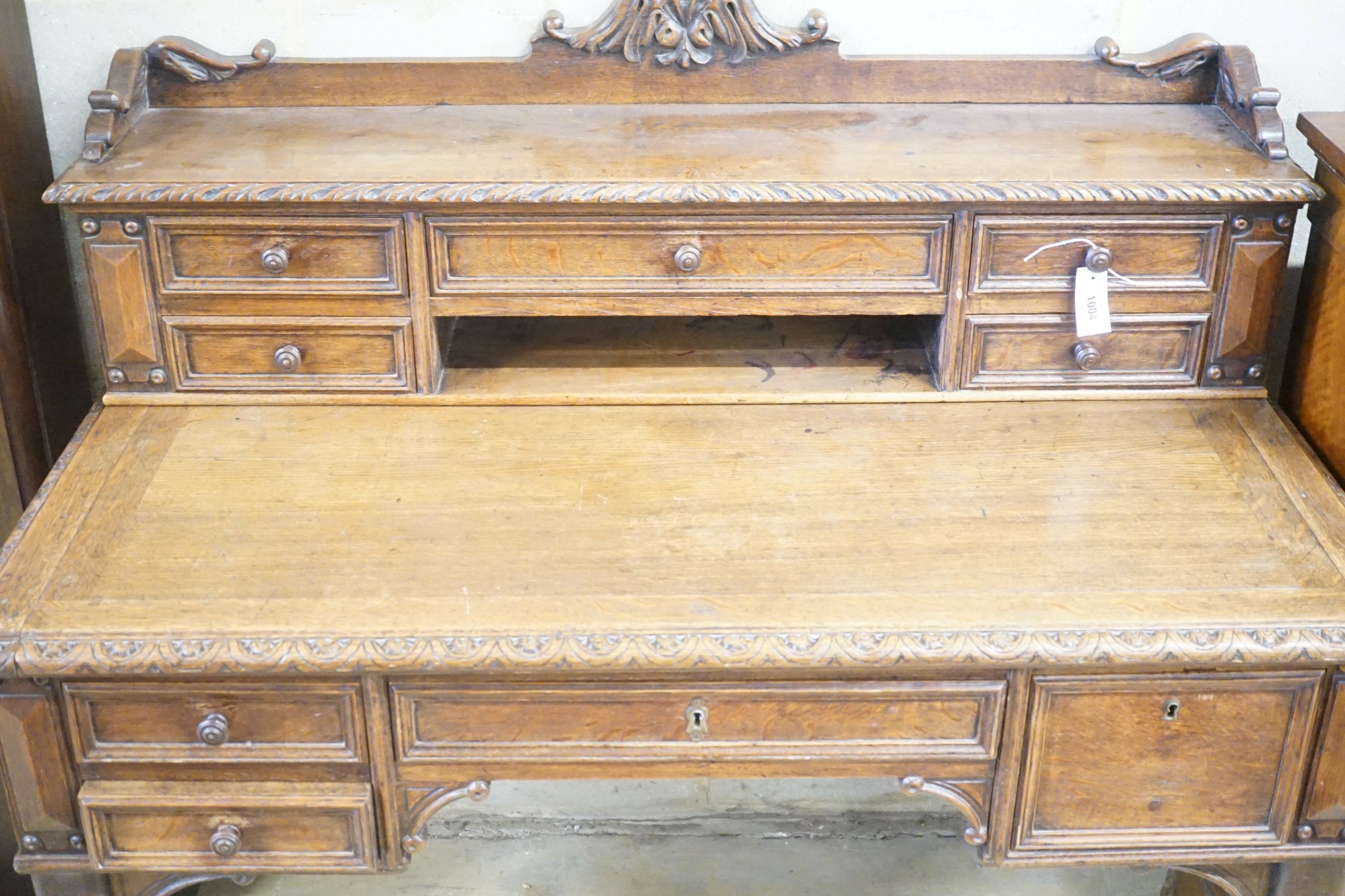 A Victorian carved oak kneehole desk, width 124cm depth 69cm height 110cm